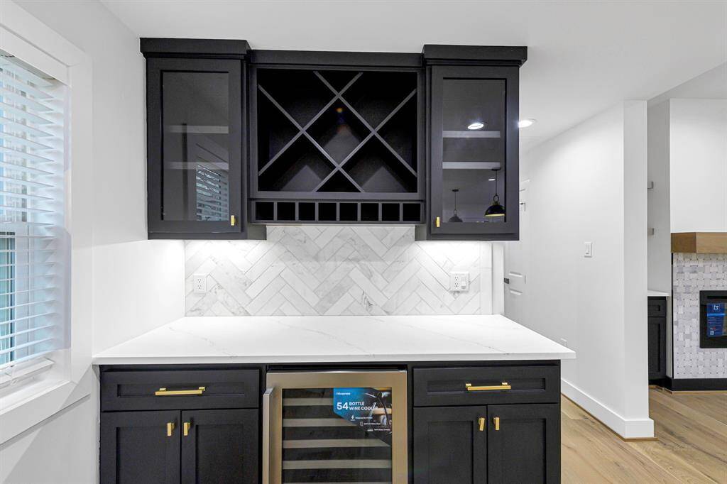 A stylish dry bar offers the perfect spot for cocktails, coffee, or extra storage.