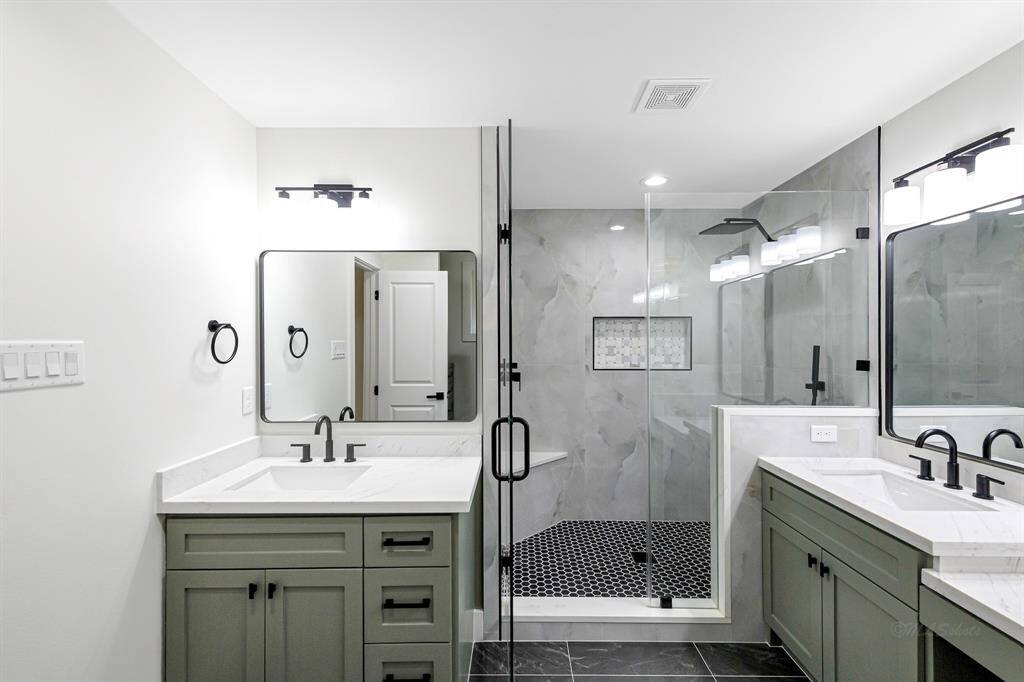 Enjoy a beautiful walk-in shower, contemporary vanity, and designer finishes in this luxurious bathroom.