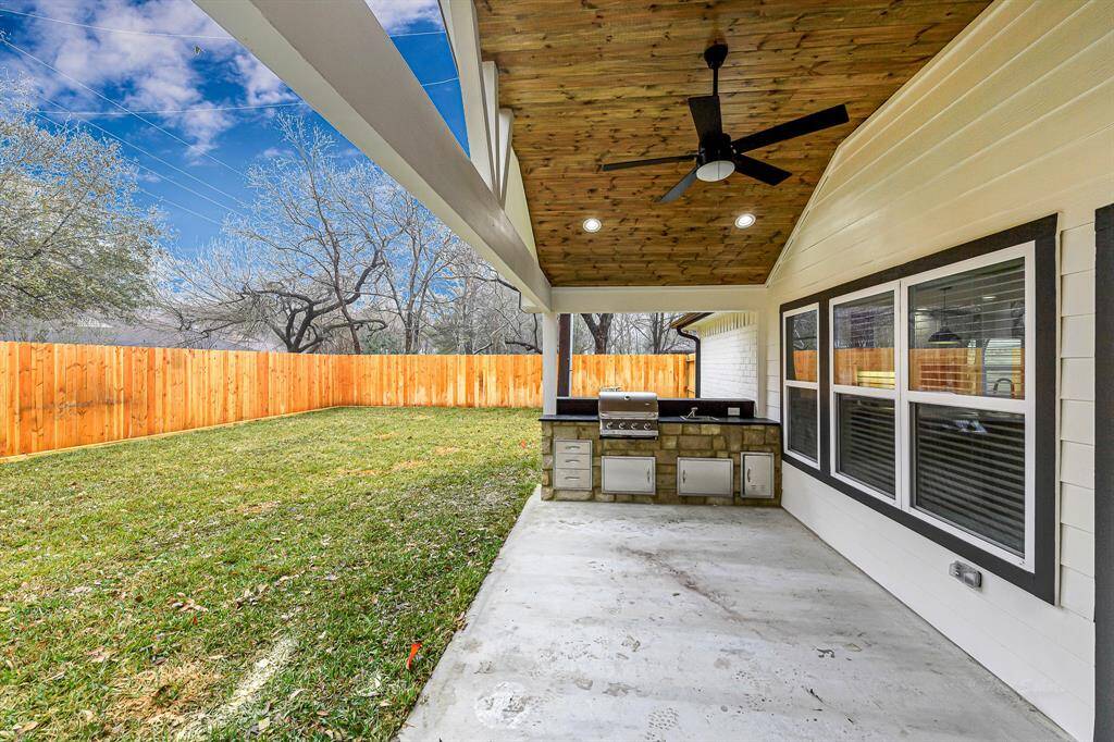 Grill, dine, and relax in this thoughtfully designed backyard oasis.