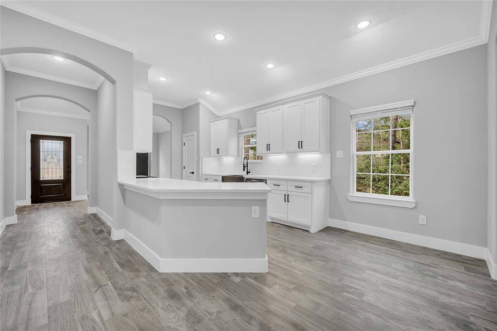 Spacious kitchen with breakfast bar and room for a breakfast table.