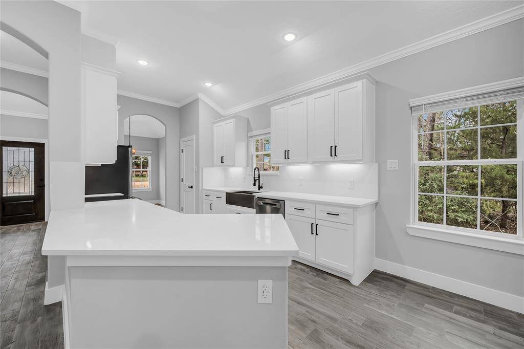 Quartz countertops, farmhouse sink, full stainless appliance package, soft close cabinets and drawers, under cabinet lighting.