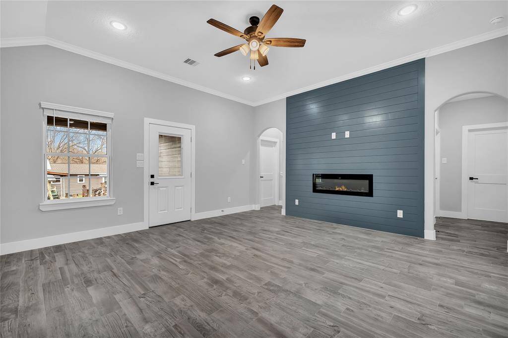 Beautiful accent wall in the living area features electric fireplace.