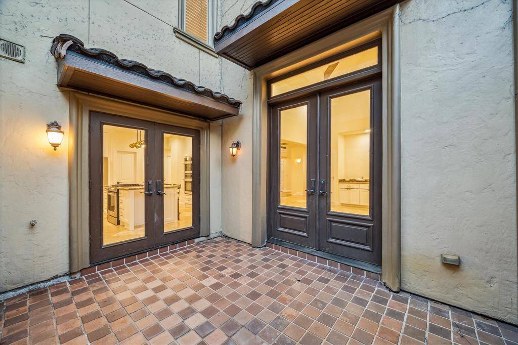 PRIVATE EXTERIOR COURTYARD… Tile flooring, masonry privacy walls, French door access from gourmet island kitchen and formal dining room. Water spigot supports easy gardening and clean-up.