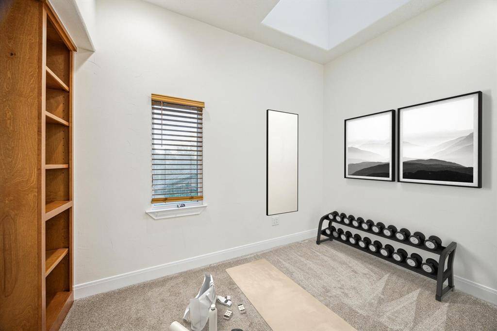 FLEX SPACE… Virtually Staged as an exercise room but could also serve as a nursery.  Features include neutral carpeting, skylight and built-in shelving. This area is extremely secluded from the rest of the house.