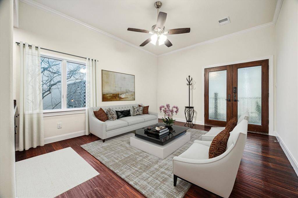 PRIMARY SUITE SITTING ROOM OR STUDY… Virtually Staged as Sitting room features engineered hardwood flooring, crown molding and French doors leading to private balcony overlooking pool/spa area to complete the feeling of a private primary retreat. The balcony leads to the pool area, which is perfect for a late-night swim. Also gives exit to the driveway.