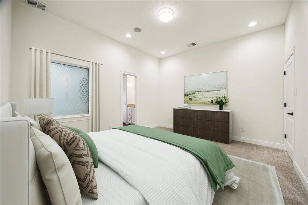 GUEST BEDROOM SUITE…  Virtually Staged.  This spacious 12’ x 14’ room is located on the second floor and has neutral carpet, a walk-in closet and ensuite full bathroom. There will be no complaining about small bedrooms in this house.