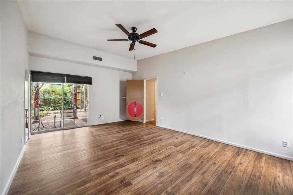 Primary bedroom also featured sliding glass doors leading out the patio area.