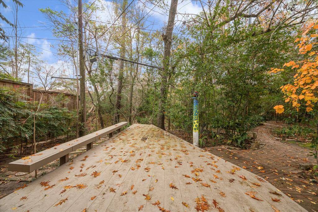 The raised wood patio extends to the edge of the property, offering a wonderful view of the creek below.