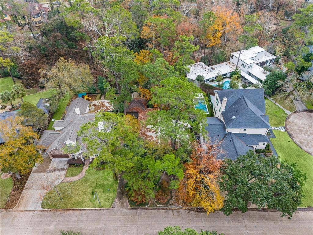 The residence is situated on a spacious 17,454 square foot lot, according to HCAD, featuring stunning trees and an open view of Rummel Creek.