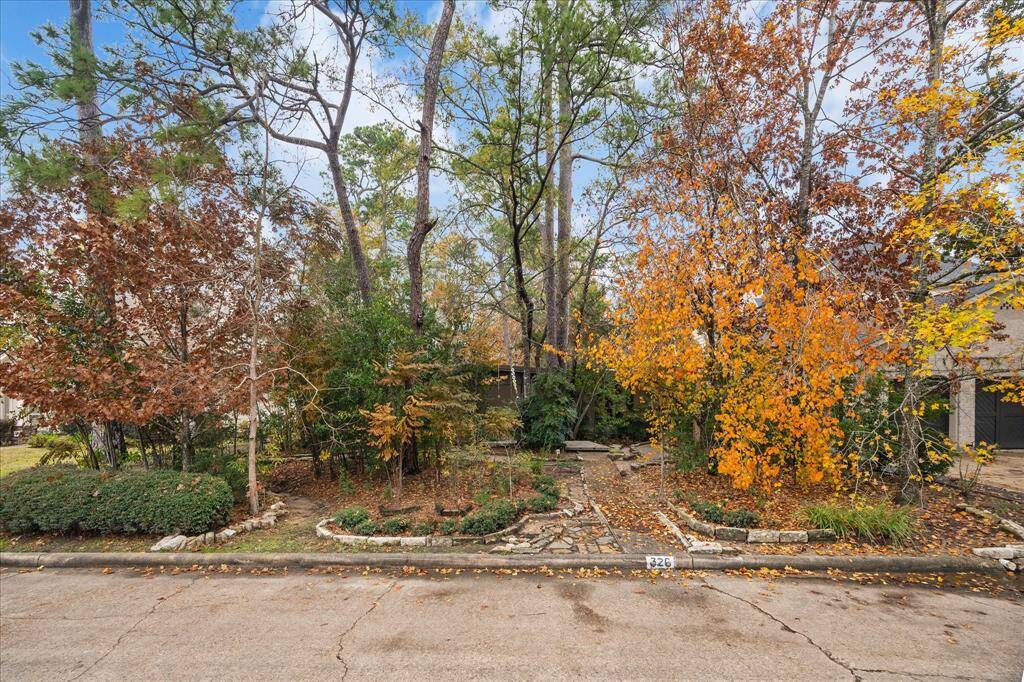 The residence is privately nestled behind the trees, offering a serene and secluded setting.