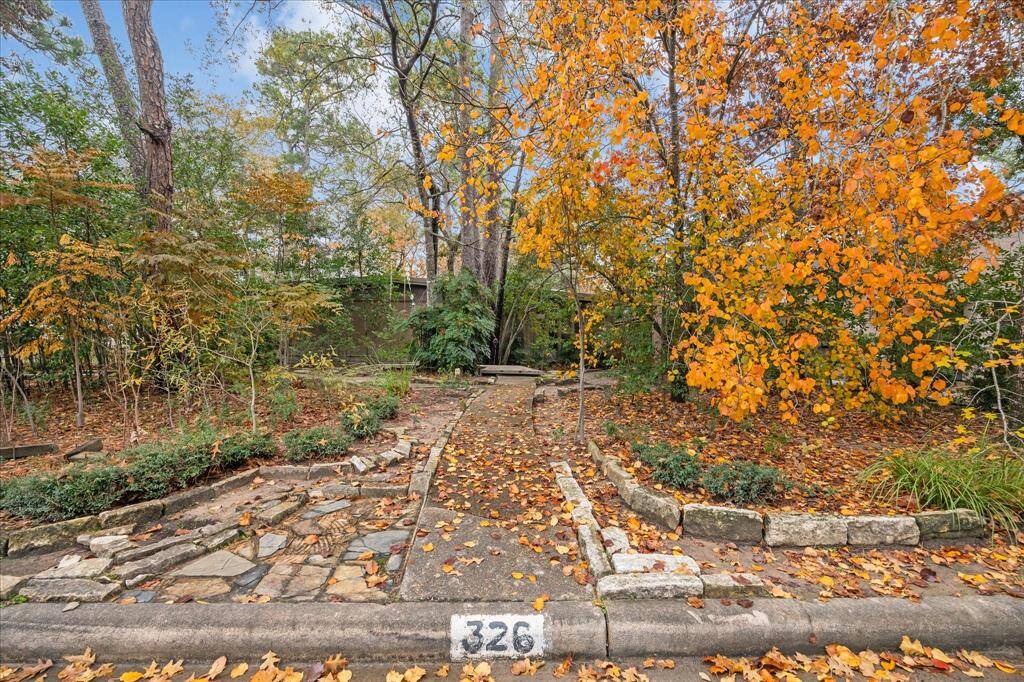 Beautiful trees and lush greenery encase the lot, creating a serene and natural setting.