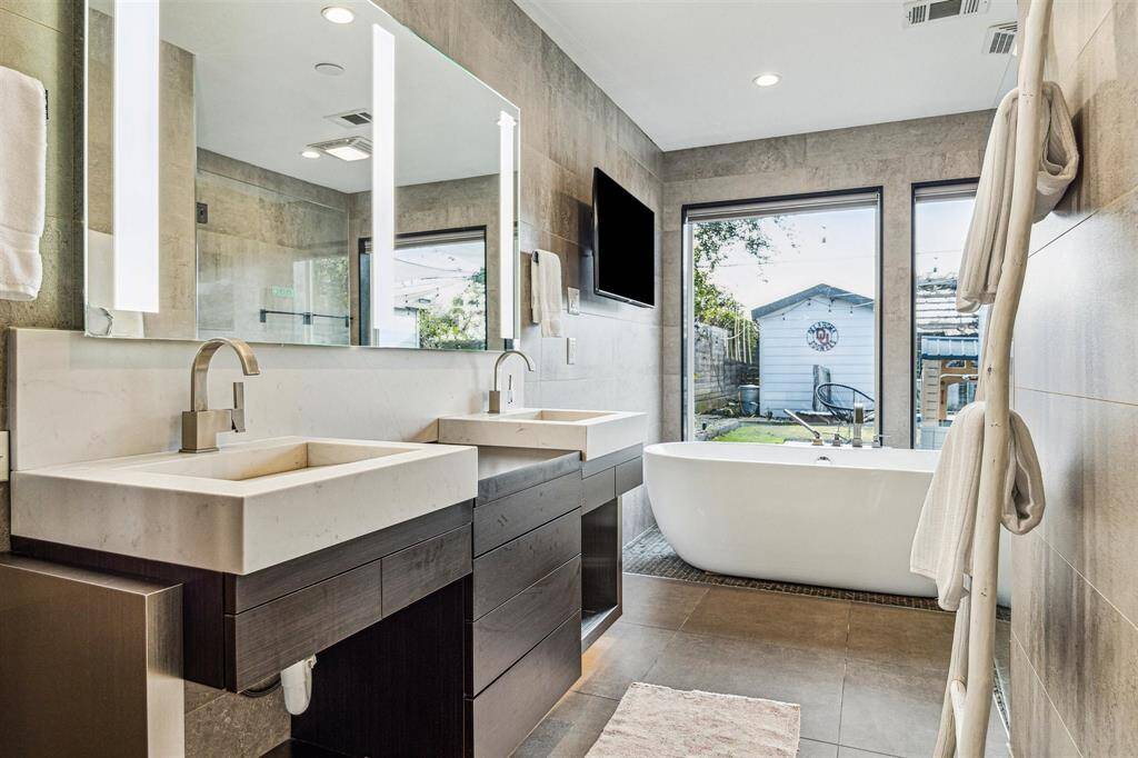 The primary bath has dual sinks, lighted vanity mirror, soaking tub, walk-in shower, and private water closet.
