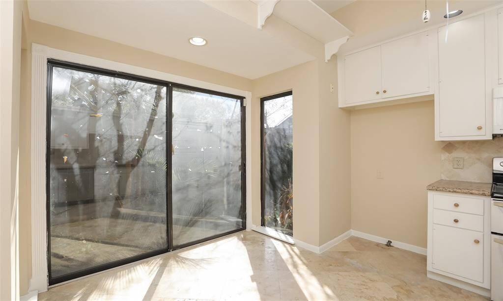 Sliding glass doors in the kitchen leading to patio/pool area