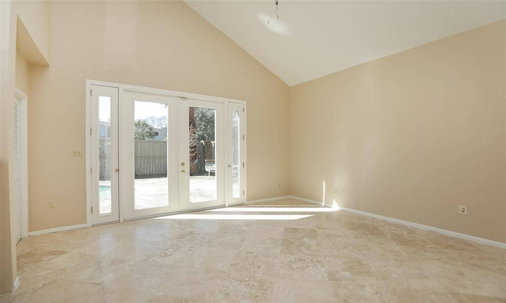 Living area with French doors leading to the patio/pool area