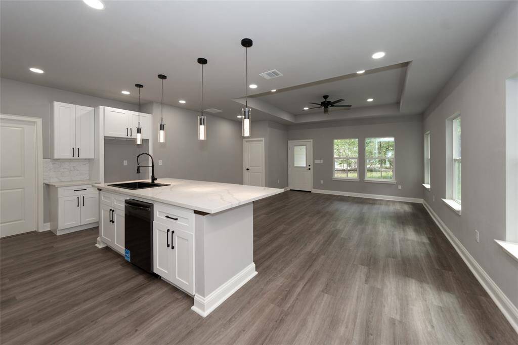 This open-concept dining area seamlessly flows into the kitchen and living room, creating a bright and spacious environment perfect for everyday living and entertaining. The modern kitchen with its sleek countertops and ample storage invites cooking and gathering, while the dining area is ideal for family meals or dinner parties. The living room, bathed in natural light, offers a cozy space to relax and unwind. The open layout ensures everyone feels connected, making this the heart of the home.