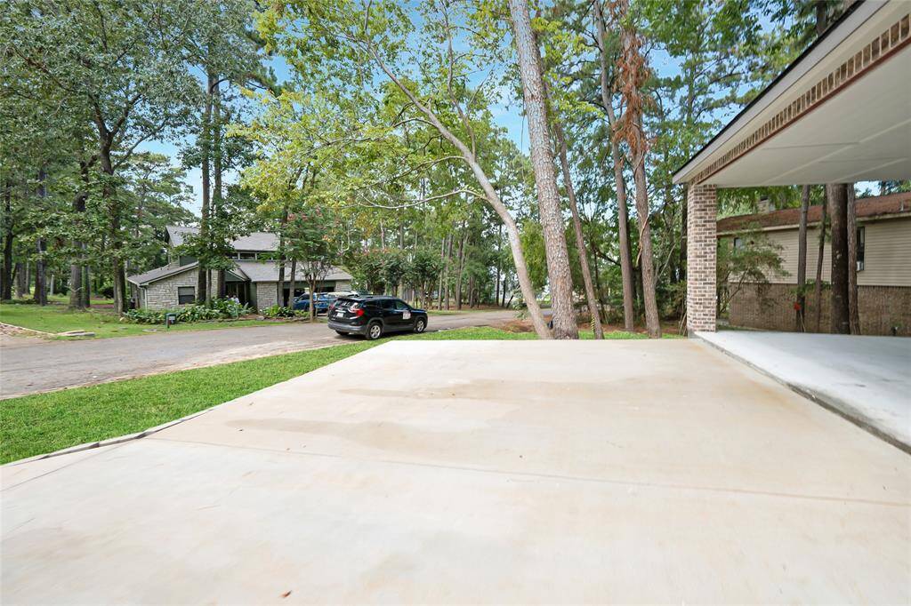 The driveway offers a sturdy and practical entry to the home, providing plenty of space for parking. Its clean, simple design adds to the home's curb appeal, offering easy access with both functionality and charm