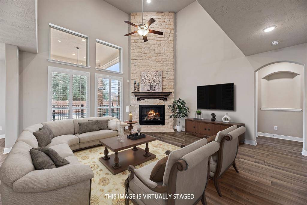 Casual elegance comes naturally in a room like this. Entertain in grand style in the living room graced by a cozy fireplace.