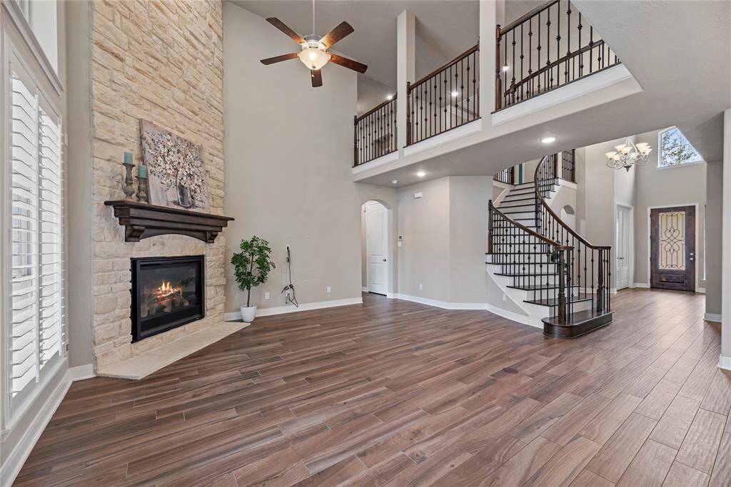 Welcome to the heart of the home, where comfort meets luxury. This family room boasts soaring open above 2-story ceilings, allowing natural light to flow through the space.