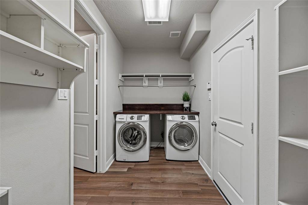 Oversized laundry room off the garage, offering ample storage space for added convenience.