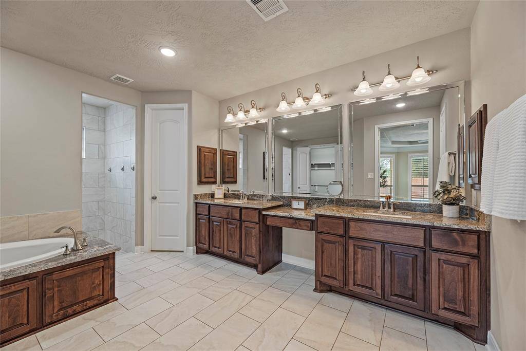 The double sink vanity and oversized mirrors lends itself to harmonious mornings.