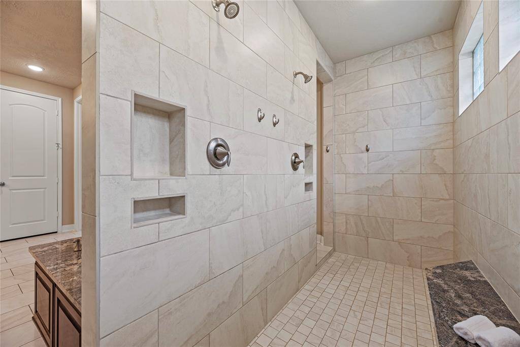 This home offers countless ways to unwind, with an expansive walk-in shower that reflects the same luxury and attention to detail found throughout the entire property.