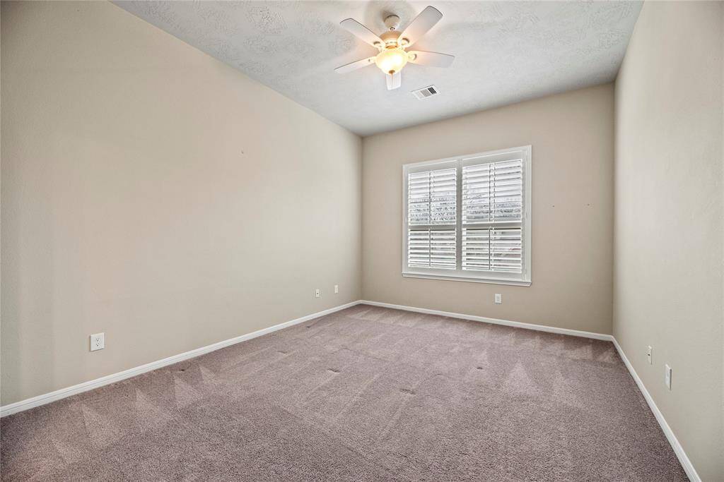 Inviting secondary bedroom with a warm, welcoming atmosphere, featuring ample space and natural light for ultimate comfort.