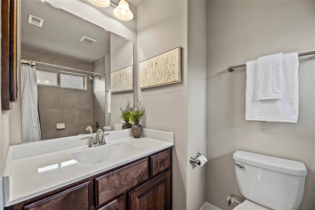 Private ensuite stylish secondary bathroom with modern finishes and ample space.