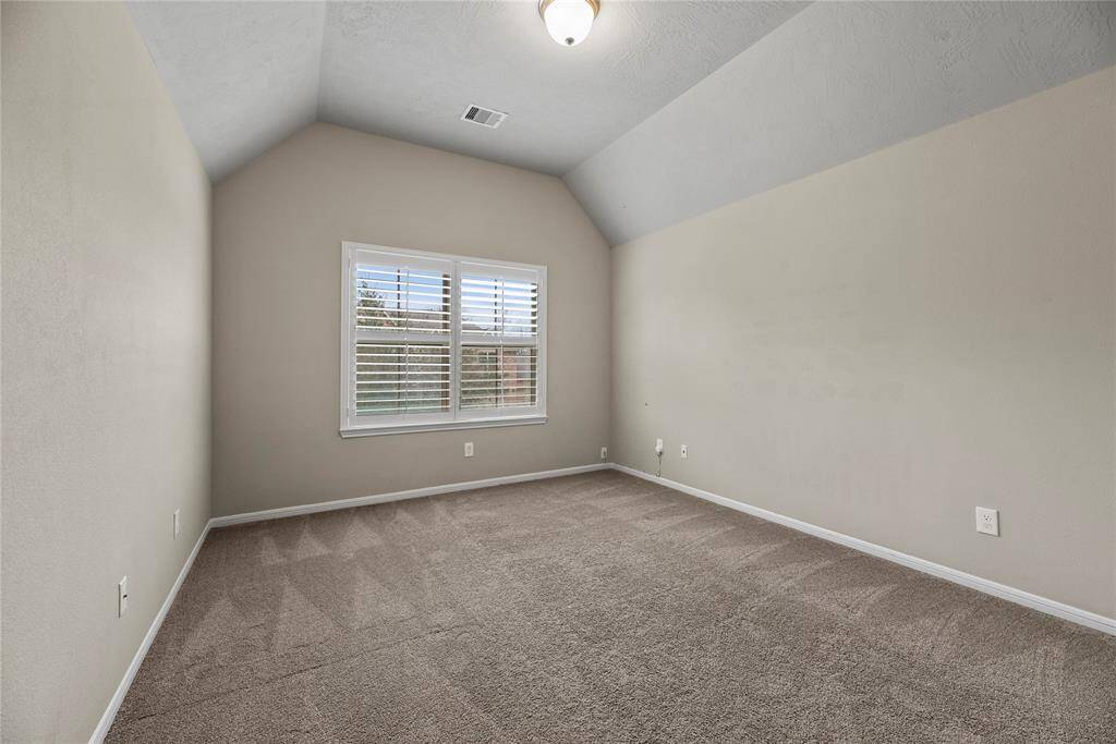 Stretch out and relax in cozy comfort in this secondary bedroom. The light pouring in from the windows makes the space bright and inviting.