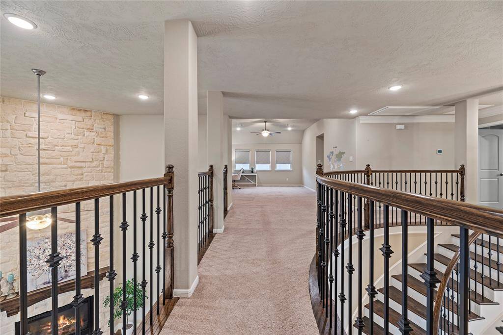 Elegant upstairs catwalk, providing a dramatic overlook of the lower level and highlighting the home's refined architectural details.