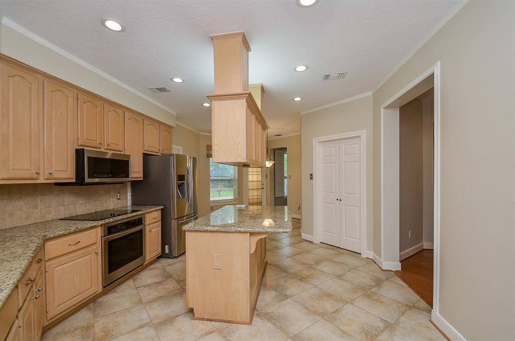 Stainless steel appliances and granite countertops is the perfect backdrop for family to gather together for prepping.
