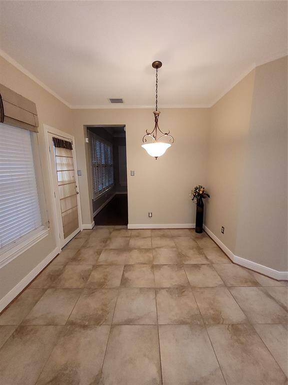 Large breakfast area adjacent to the kitchen with access to the backyard. The door at the far end leads to the family room.
