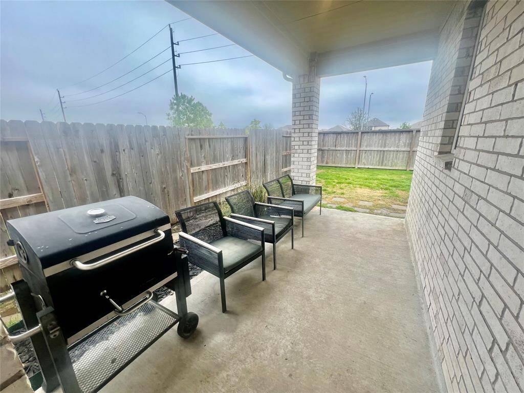 Covered patio with bbq pit and patio furniture