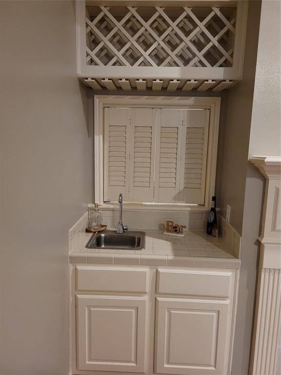 A wet bar area, next to the fireplace, is the other side of the pass through bar into the formal living.