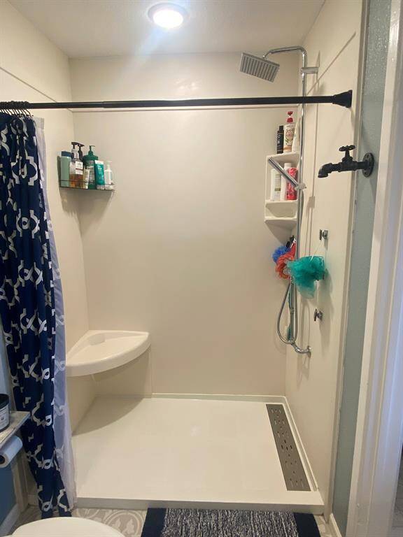 Spacious Shower only  in primary bath with modern rain shower fixture