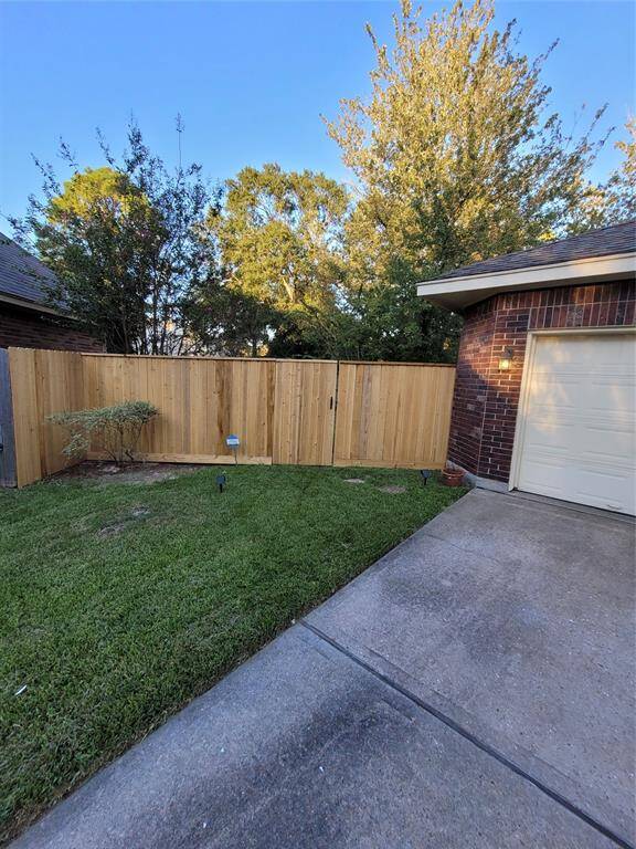 New fence installed on the side of the garage.