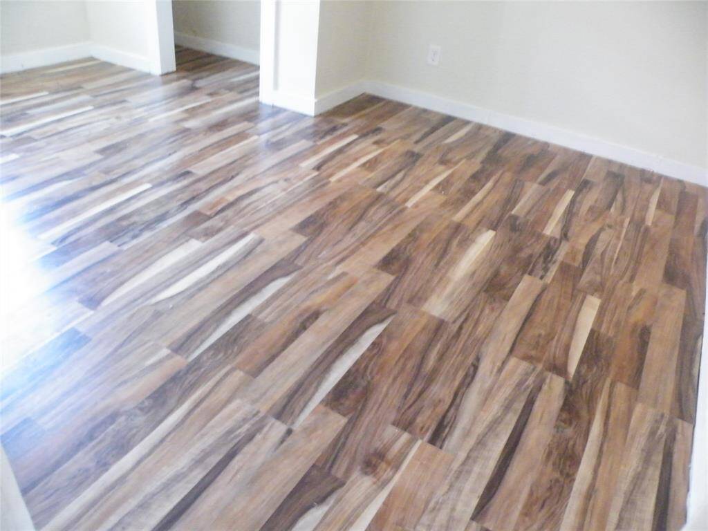 One of 3 bedrooms with wood laminate flooring