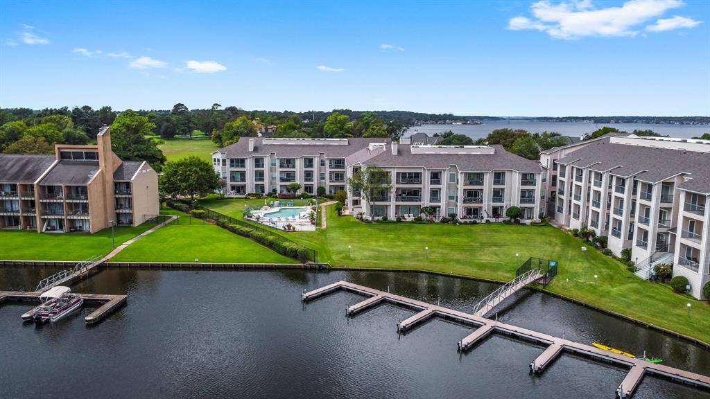 This property features modern waterfront condominiums with direct access to a private dock and boat slips. Enjoy a communal swimming pool and lush green spaces, all set against the backdrop of a serene lake view. Ideal for those seeking a blend of luxury and nature.