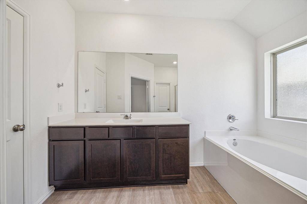 The primary bathroom features a modern design with natural light