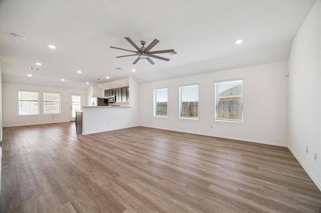 The living area seamlessly connects to a kitchen area with a bar counter, ideal for entertaining.