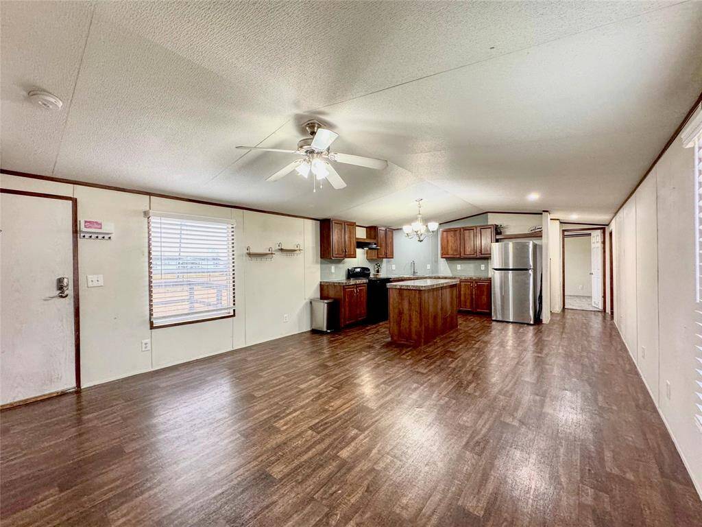 Living room flows into island kitchen and options for dining.