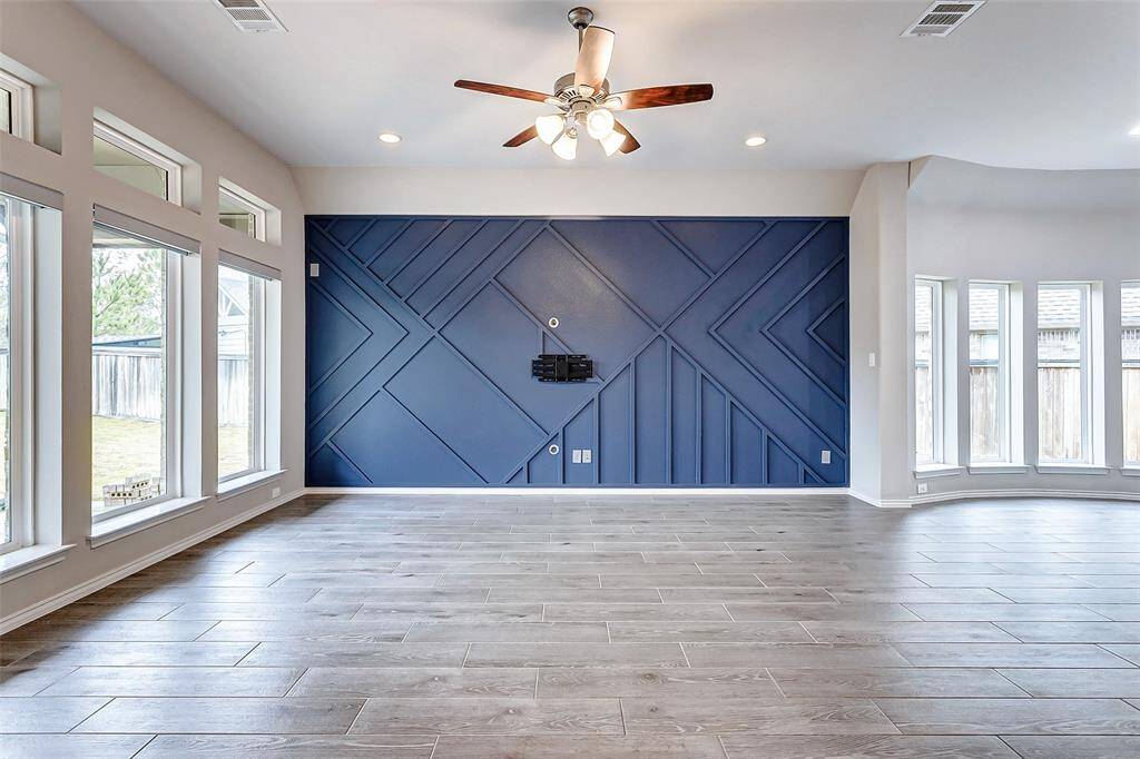 Stylish navy accent wall with geometric designs contrasts beautifully with bright white walls.