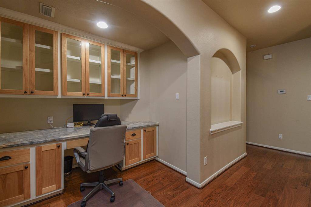 Upstairs features a stylish built-in desk, perfect for a home office or study area.