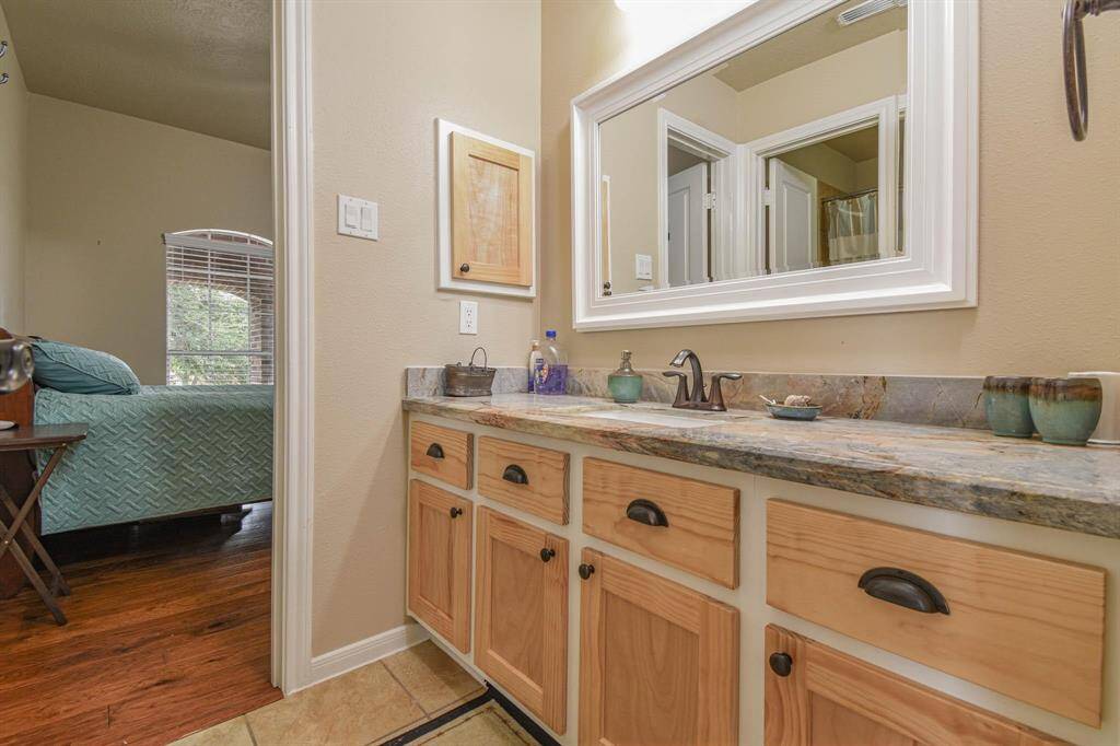 Stylish upstairs bathroom with elegant fixtures and ample counter space, perfect for your daily routine.