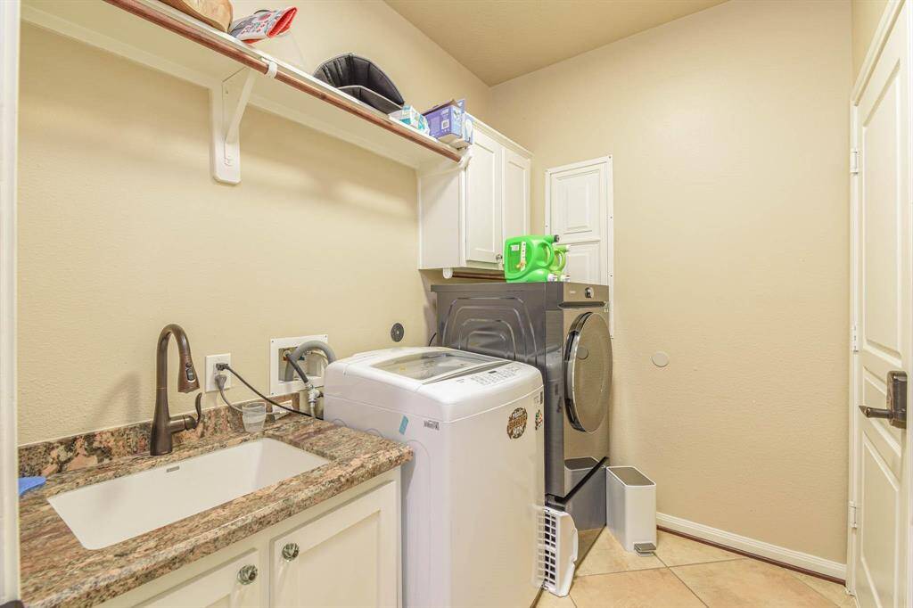 Efficient laundry room featuring modern appliances and ample storage.