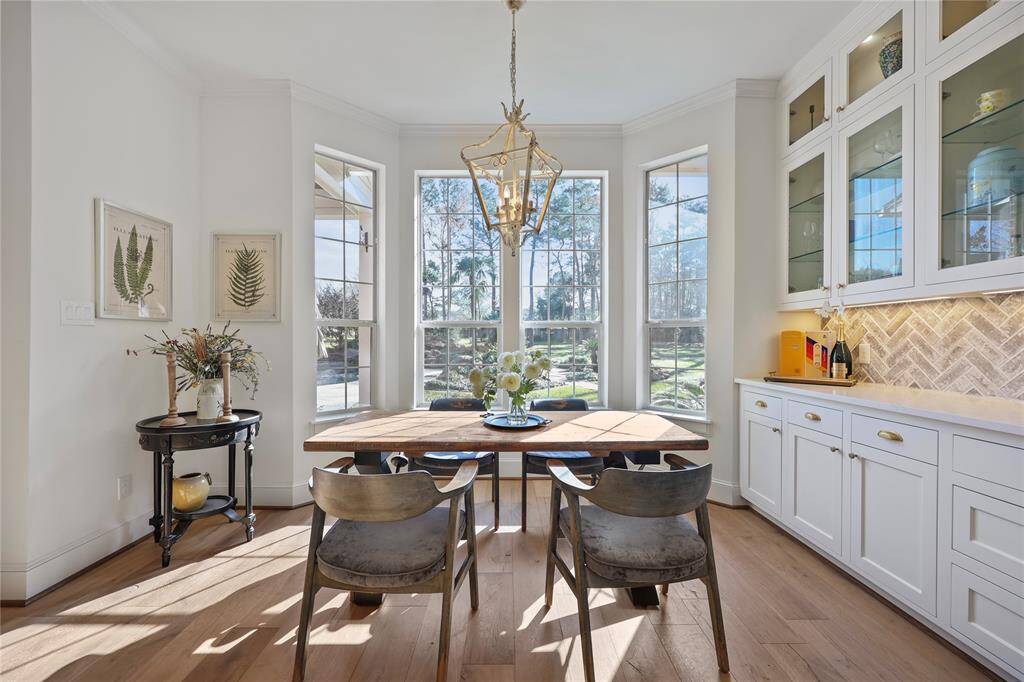 This kitchen area exudes a warm and inviting ambiance. The large bay window gives beautiful views of the back yard and pond.