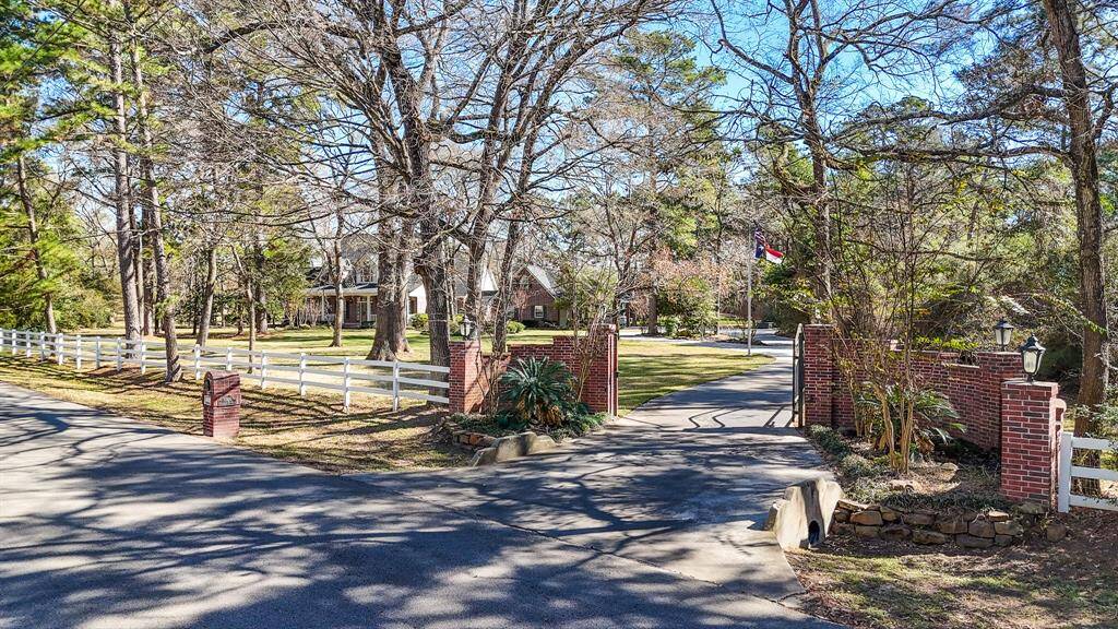 As you enter the property you are greeted by a gate and winding driveway, mature trees and beautifully landscaped yard. The home is set back for privacy.