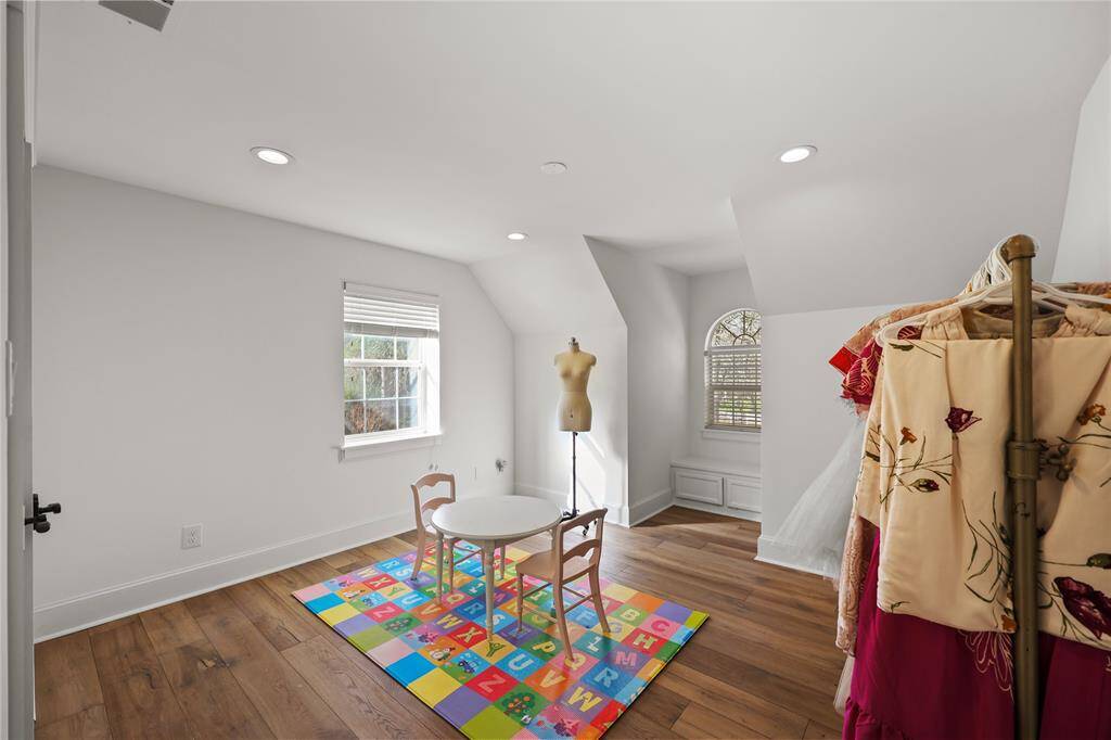 This additional bedroom features the same beautiful flooring, recessed lighting and oversized baseboards.