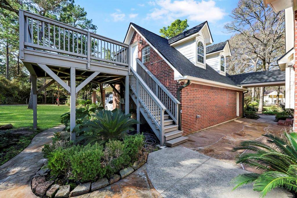 This deck and staircase leading to an additional room over the garage were replaced in January 2024. The garage has a water holding tank that was replaced in Sept 2023