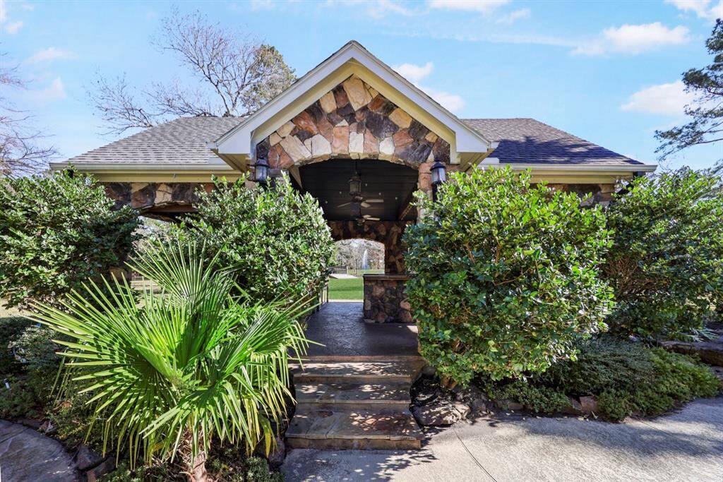 The stone covered pavilion is home to the outdoor kitchen.  Skillfully decorated and designed with a resort retreat in mind.