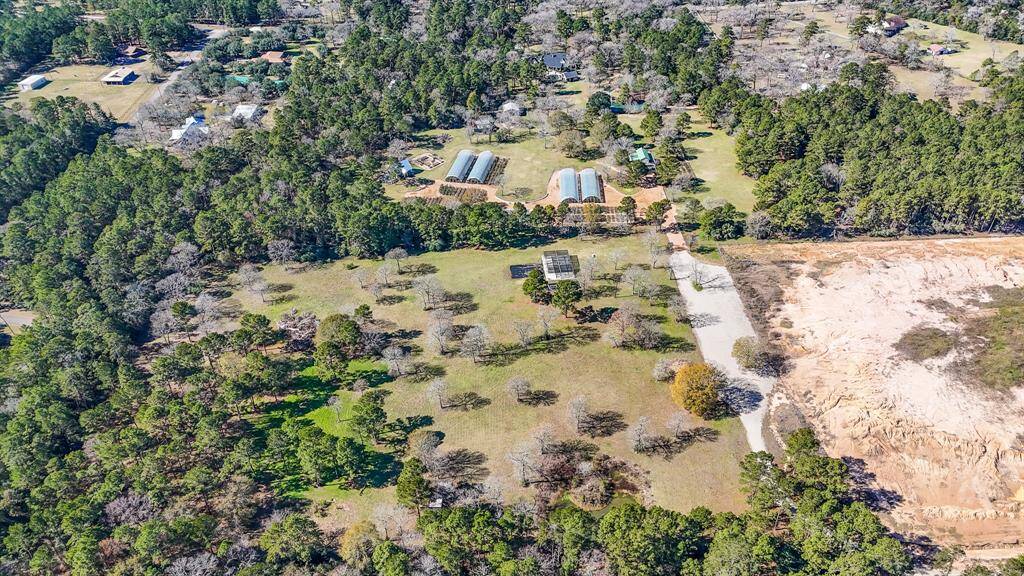And adjacent to the @10-acre rose farm is another @12-acre tract which also has it's own private road that leads to Grand Pines. This is for sale, is unrestricted and ag-exempt.